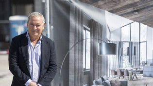 Orascom DH, das Unternehmen von Samih Sawiris, schrieb im ersten Halbjahr 2022 wieder schwarze Zahlen. Im Bild: Sawiris vor einem Bild eines Zimmers des Haus Alpenrose in Andermatt 2017. (Archivbild)
